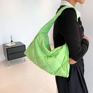 Macro detail of fluorescent green quilted nylon shoulder bag with soft padding