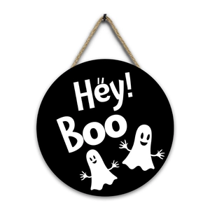 Detail of round wooden Halloween sign with Hey Boo text and cute ghost illustrations
