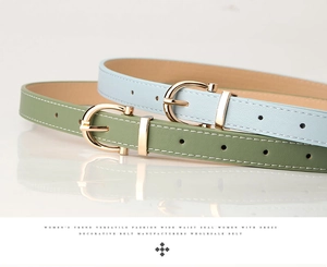 Detail of olive green and light blue PU leather belts with golden horseshoe metal buckles