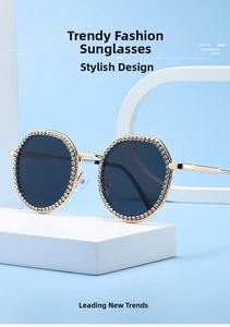 Detail of light gold metal frame sunglasses with white rhinestones and dark lenses