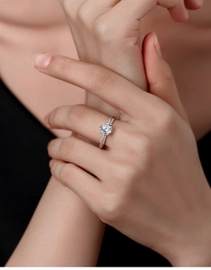 Detailed view of an elegant S925 sterling silver ring with a one carat moissanite on a finger