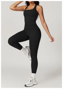 Detail of high-elastic black yoga set with racerback top and high-waist lifting leggings