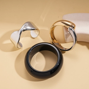 Minimalist geometric metal bangle set with gold, silver and black resin finishes