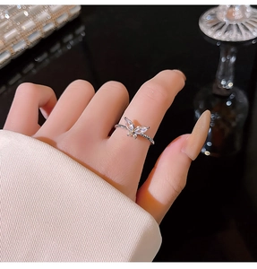 Close-up of a silver-toned butterfly ring with sparkling marquise-cut zircon stones