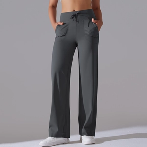 Detail view of high waisted drawstring waistband and side pockets on grey wide leg yoga pants