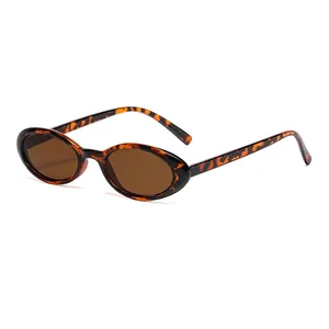 Fashion oval sunglasses with tortoise shell frames and brown lenses on white background