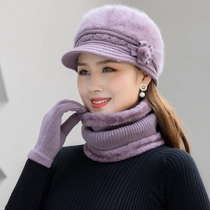 Close-up of purple winter knit hat set with neck warmer and gloves on a model