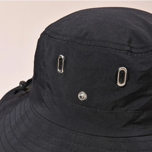 Black outdoor sun hat with silver eyelets and adjustable drawstring for hiking and fishing