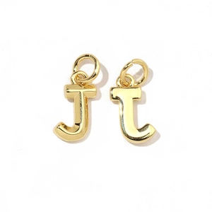 Detailed macro view of two 18K gold-plated letter J charms with smooth metallic finish