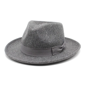 Detail view of the thick wool felt texture and decorative bow on this dark grey fedora hat