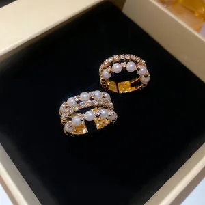 Elegant multi-layer gold ring with white pearls and sparkling crystals in a gift box