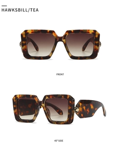 Macro detail of tortoiseshell square sunglasses with golden sphere temple ornaments