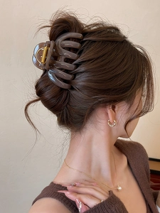Close-up of a large tortoiseshell claw clip securing a chic updo hairstyle for women