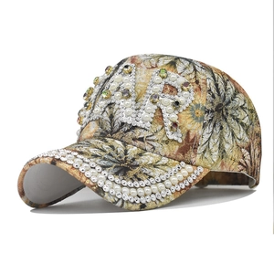 Close-up of pearl AR letters and crystal embellishments on the floral baseball cap