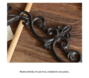 Detail of vintage cast iron scrollwork with a matte black finish and rustic texture