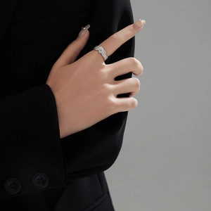 Detailed view of irregular textured silver ring with sparkling round centerpiece stone