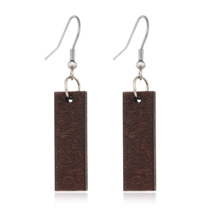 Close-up of retro rectangular dark wood dangle earrings with silver metal hooks