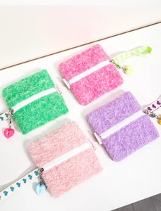 Macro shot of fluffy square coin purses in multiple colors with heart pendant and zipper