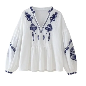 White boho cotton blouse with blue embroidery, deep V-neck and puff sleeves for women