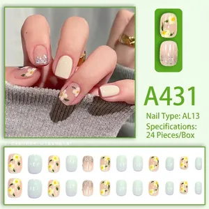 Short mint green press-on nails with daisy floral designs and glitter sequins kit