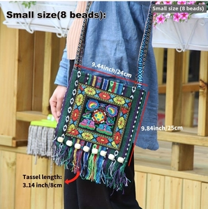 Detail showing colorful floral embroidery and tassel fringe on ethnic canvas crossbody bag