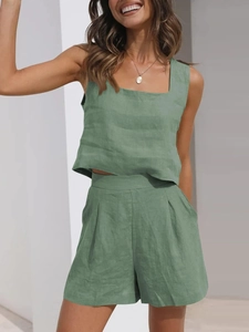 Detailed texture of light green linen fabric on sleeveless top and high-waist shorts set