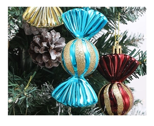 Close-up of glitter candy Christmas tree ornaments in blue, red, and gold colors
