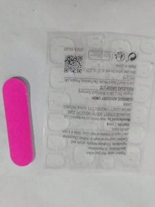 Macro view of 24-piece nail glue sticker sheet with pink nail file tool set