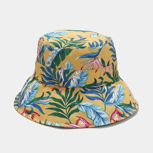 Detail view of tropical floral print on foldable yellow sun bucket hat for women