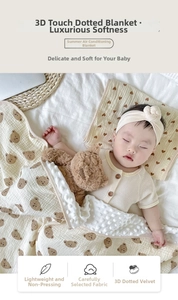 Detail of 3D sensory dotted baby blanket with cute brown bear prints in soft beige fabric