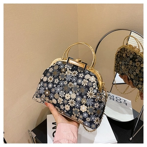 Detailed embroidery floral handbag featuring gold metal clasp closure and chain strap