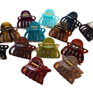 French style acrylic pumpkin hair claws in multiple colors like red, amber and green