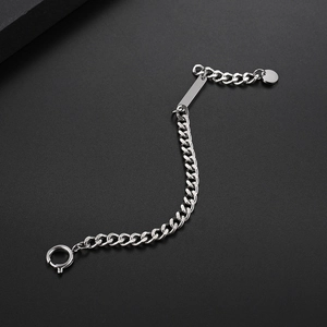 Macro view of silver Cuban link bracelet with rectangle metal plate and spring clasp