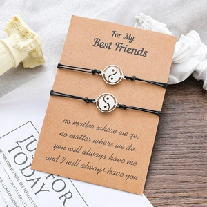 Yin Yang braided friendship bracelets with stainless steel pendants on gift card