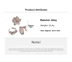 Detail view of silver alloy floral ring set with irregular textured geometric patterns
