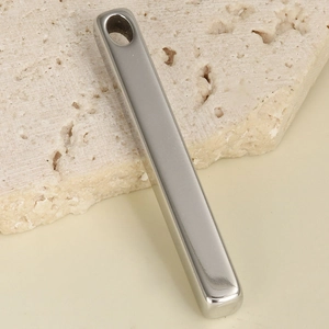 Minimalist silver 304 stainless steel long bar pendant on natural beige stone