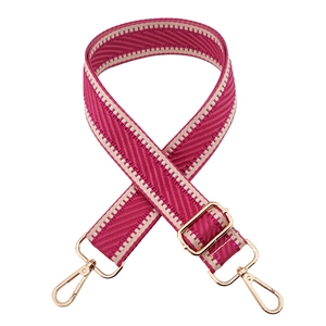 Pink and beige herringbone woven bag strap with adjustable gold-toned metal buckles