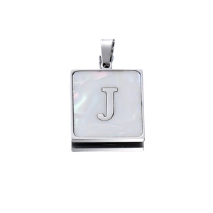 Macro shot of silver square letter J pendant with iridescent white shell inlay detail