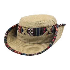 Detailed view of the colorful ethnic woven band and stitch work on a khaki sun hat