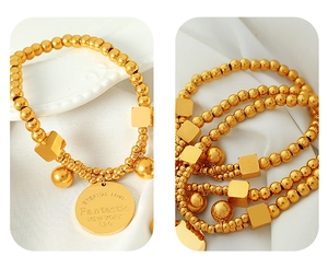 Detailed macro view of 18k gold beads and engraved square charms on elastic bracelet