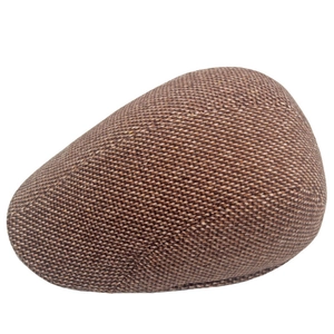 Close-up of brown and beige tweed pattern on a men's vintage flat cap for winter