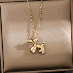 Detailed macro of golden balloon dog pendant necklace with micro-pave cubic zirconia stones