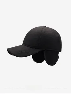 Detail view of winter baseball cap with integrated ear flaps and metallic SORT side badge