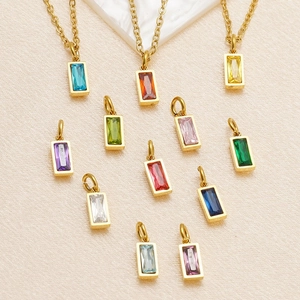 Detailed view of rectangular birthstone pendants in 18K gold-plated stainless steel setting