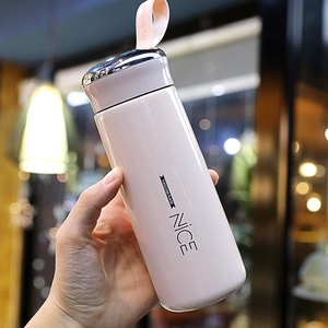 Pink stainless steel vacuum flask with silver lid and silicone strap in hand