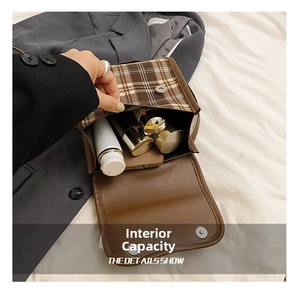 Detailed internal capacity view of vintage plaid backpack with phone and cosmetics