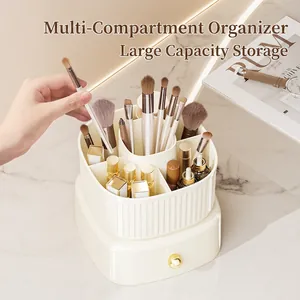 Rotating makeup organizer with multiple compartments and drawer on marble countertop