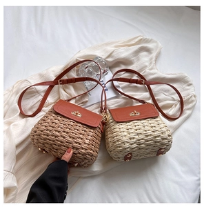 Detail of hand-woven straw crossbody bags in brown and beige with leather flap and metal lock