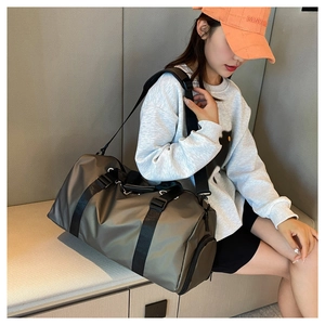 Detail of waterproof nylon fitness travel bag with adjustable strap and satin finish