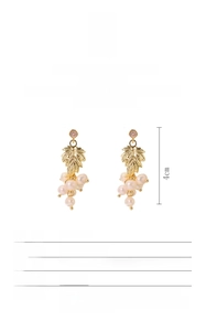 Detail view of 18k gold plated grape leaf earrings with natural baroque pearl pendants